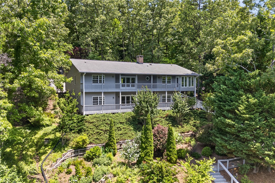 9 Lookout Lane Salem, SC 29676 - Photo 30 of 46 Perched among verdant trees, this hillside retreat offers multiple decks and extensive landscaping.