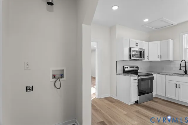 a kitchen with a sink a stove and refrigerator