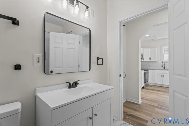 a bathroom with a sink a toilet and a mirror