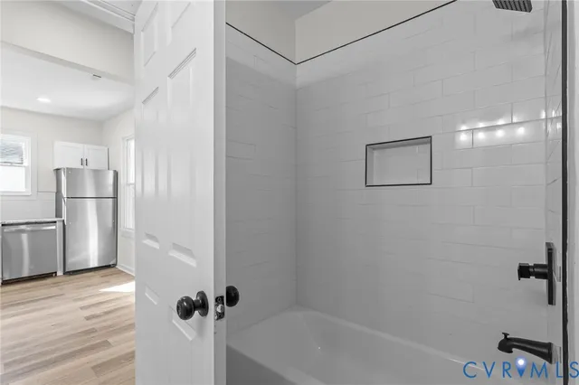 a bathroom with a tub and shower