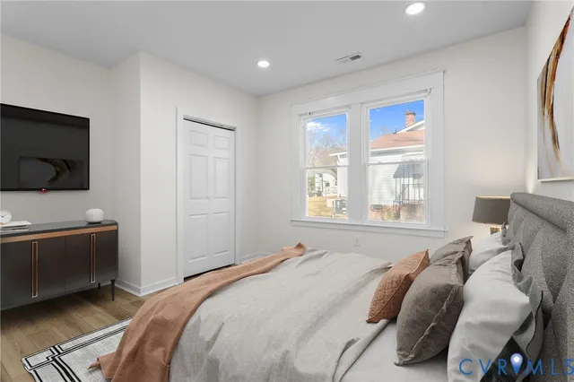 a bedroom with a bed and a flat screen tv