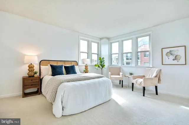 a spacious bedroom with bed and a large window