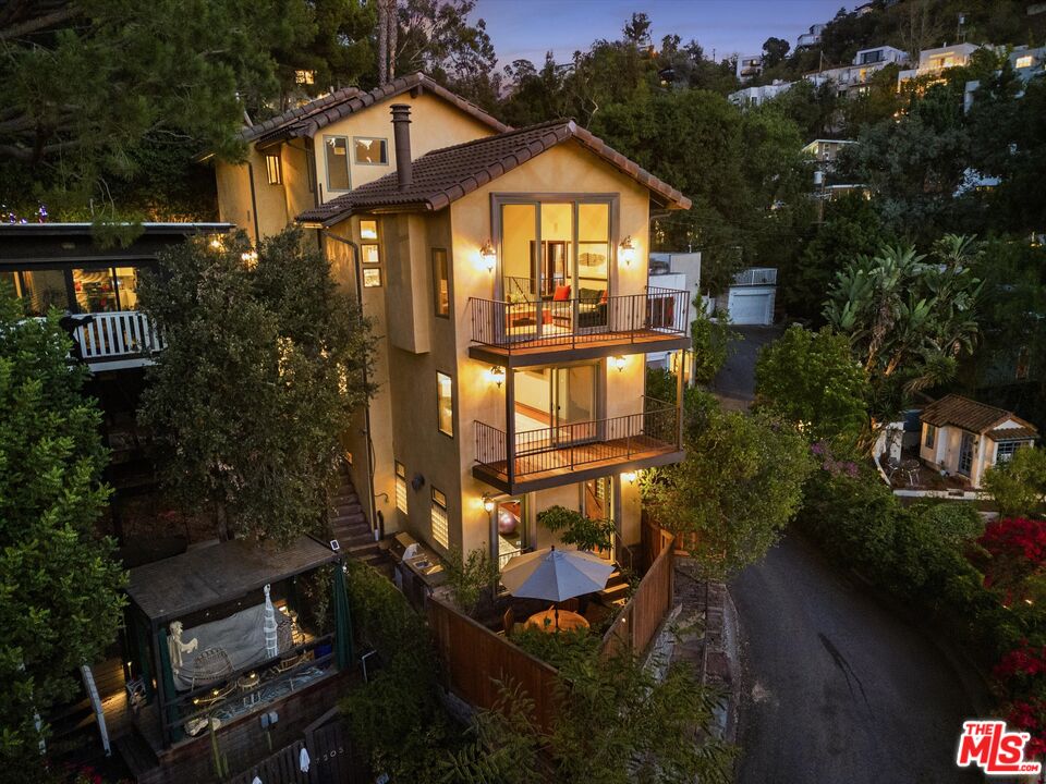 7223 Sycamore Trail Los Angeles, CA 90068 - Photo 1 of 62 a front view of a house with garden