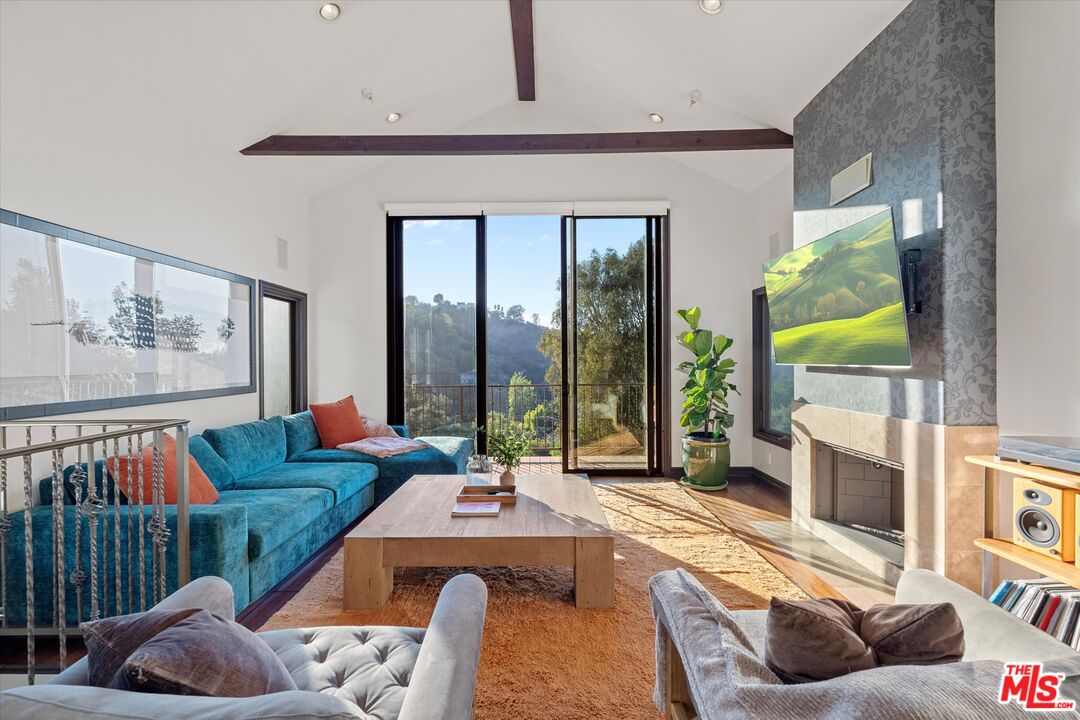 7223 Sycamore Trail Los Angeles, CA 90068 - Photo 12 of 62 a living room with furniture and a floor to ceiling window