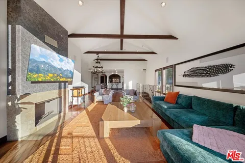 a living room with fireplace furniture and a flat screen tv