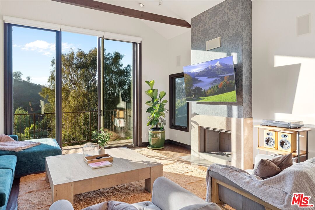 7223 Sycamore Trail Los Angeles, CA 90068 - Photo 14 of 62 a living room with fireplace furniture and a large window