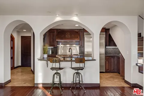 a livingroom view with chairs and wooden floor