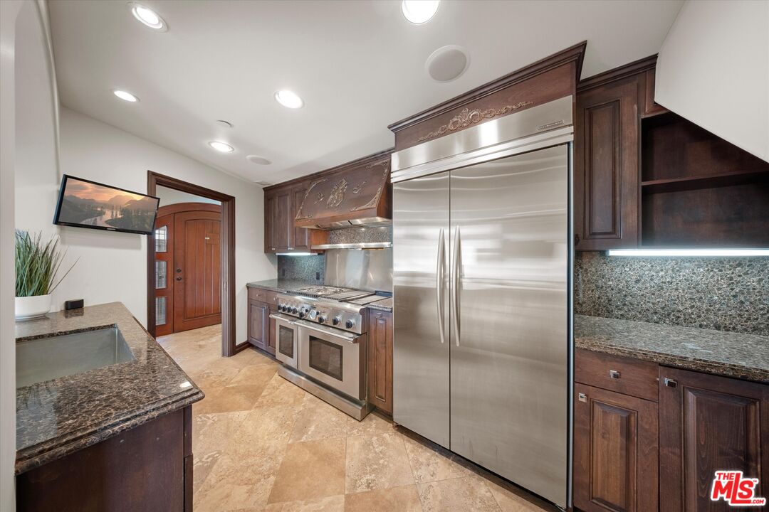 7223 Sycamore Trail Los Angeles, CA 90068 - Photo 18 of 62 a kitchen with stainless steel appliances granite countertop a refrigerator and a sink