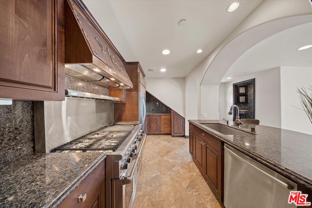 7223 Sycamore Trail Los Angeles, CA 90068 - Photo 19 of 62 a kitchen with stainless steel appliances granite countertop a sink and stove