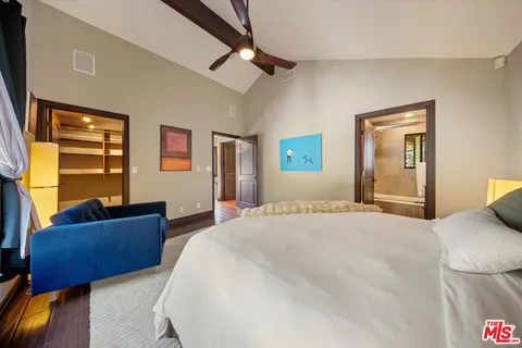 a bedroom with a bed couch and a window