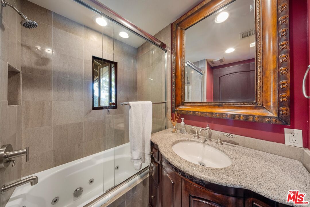 7223 Sycamore Trail Los Angeles, CA 90068 - Photo 24 of 62 a bathroom with a granite countertop sink and a mirror