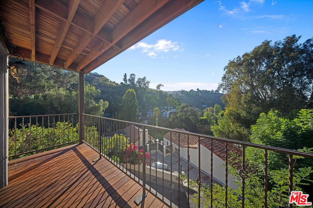 7223 Sycamore Trail Los Angeles, CA 90068 - Photo 30 of 62 a balcony with wooden floor and yard in the back