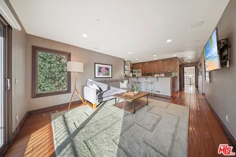 a kitchen with granite countertop stainless steel appliances a refrigerator a stove top oven a sink and cabinets