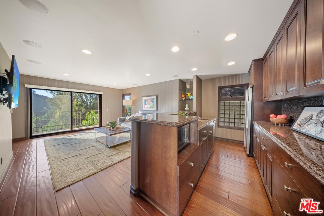 7223 Sycamore Trail Los Angeles, CA 90068 - Photo 33 of 62 a living room with stainless steel appliances granite countertop furniture wooden floor and a large window
