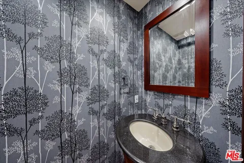 a spacious bedroom with a bed and a flat screen tv