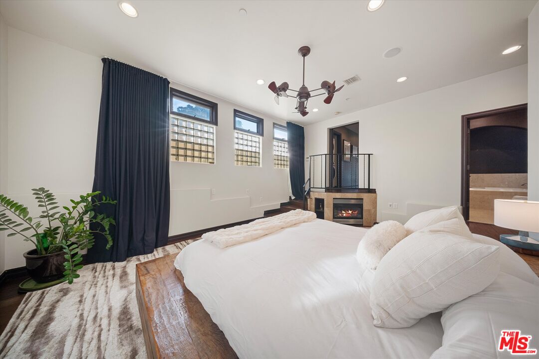 7223 Sycamore Trail Los Angeles, CA 90068 - Photo 37 of 62 a spacious bedroom with a bed and a flat screen tv