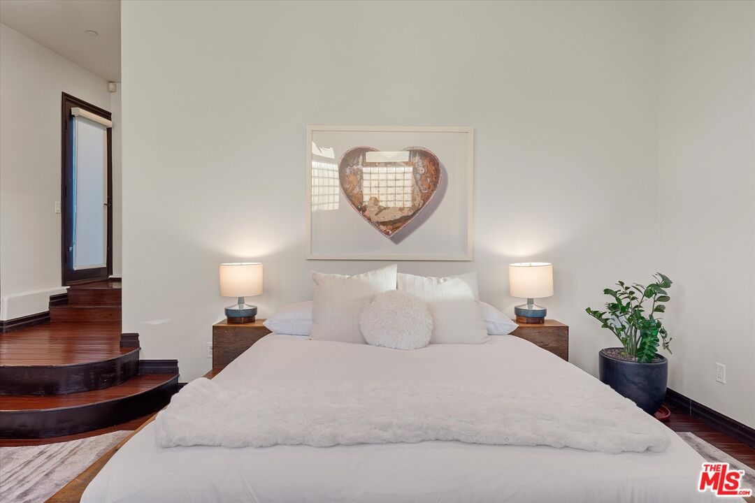 7223 Sycamore Trail Los Angeles, CA 90068 - Photo 38 of 62 a bedroom with a bed and a potted plant