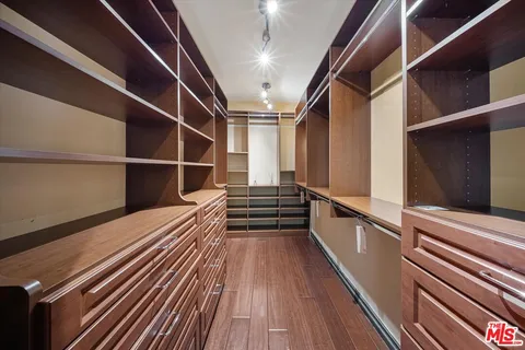 a bathroom with a granite countertop bathtub sink vanity mirror and toilet