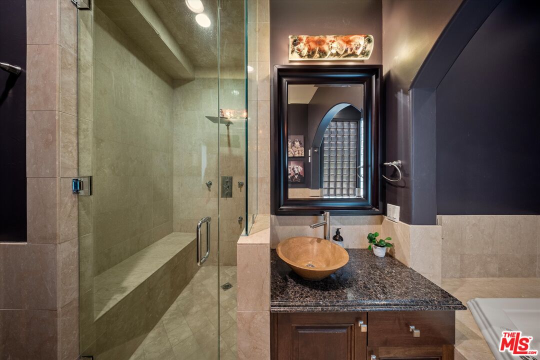 7223 Sycamore Trail Los Angeles, CA 90068 - Photo 42 of 62 a bathroom with a granite countertop sink and a mirror