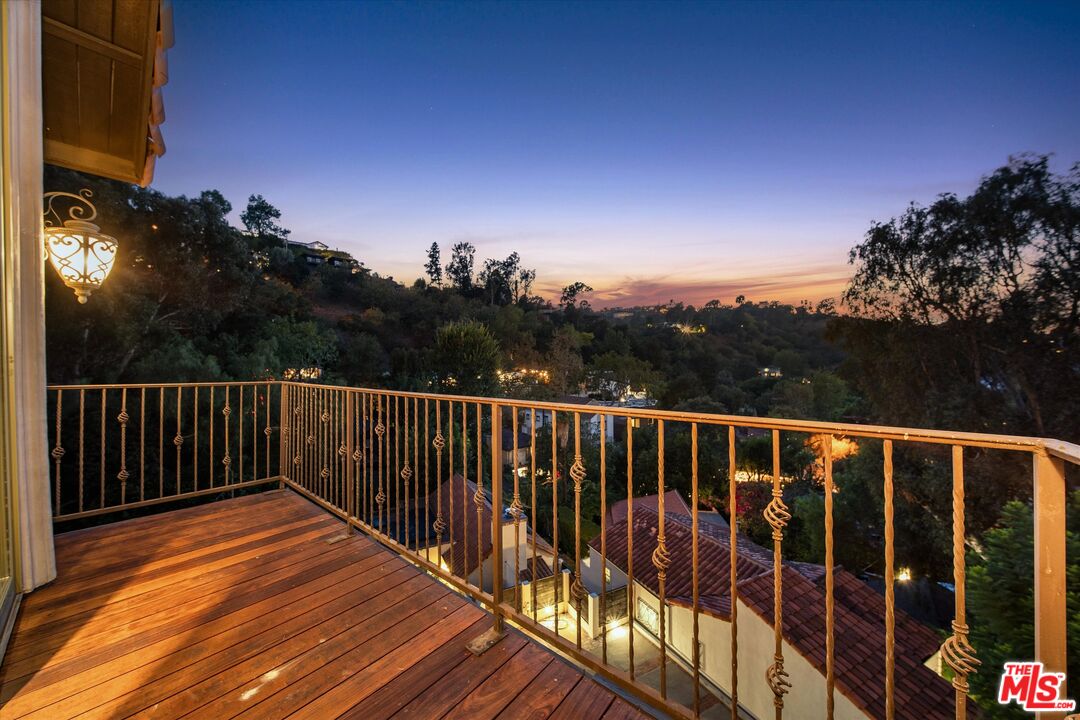 7223 Sycamore Trail Los Angeles, CA 90068 - Photo 6 of 62 a balcony with wooden floor and fence