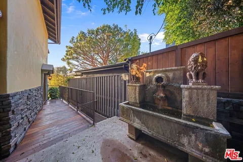 a view of a small house with wooden fence
