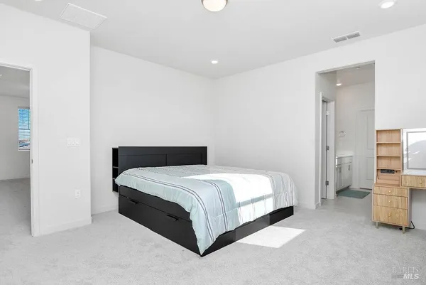 a spacious bedroom with a bed and a couch