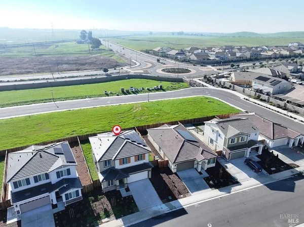 an aerial view of a tennis ground with a big yard