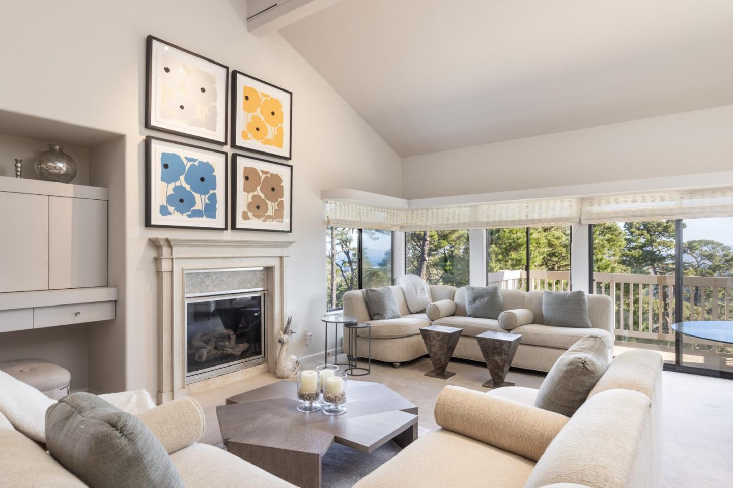 a living room with furniture a fireplace and a large window