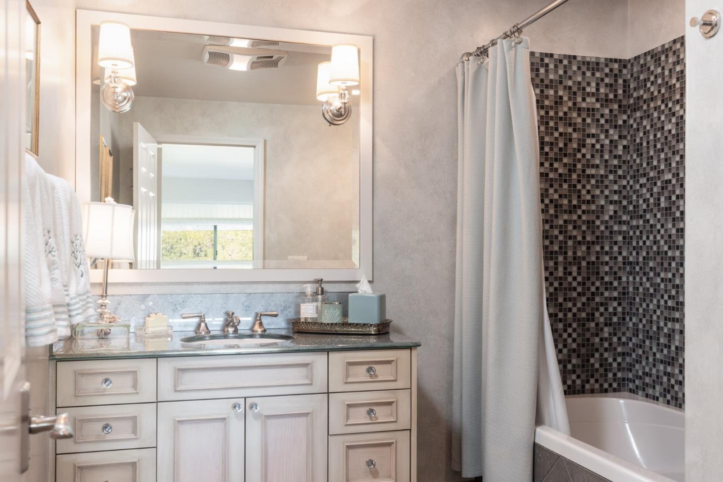 38 Shepherds Knoll Road Monterey, CA 93940 - Photo 21 of 22 a bathroom with a granite countertop sink a toilet a mirror a vanity and shower