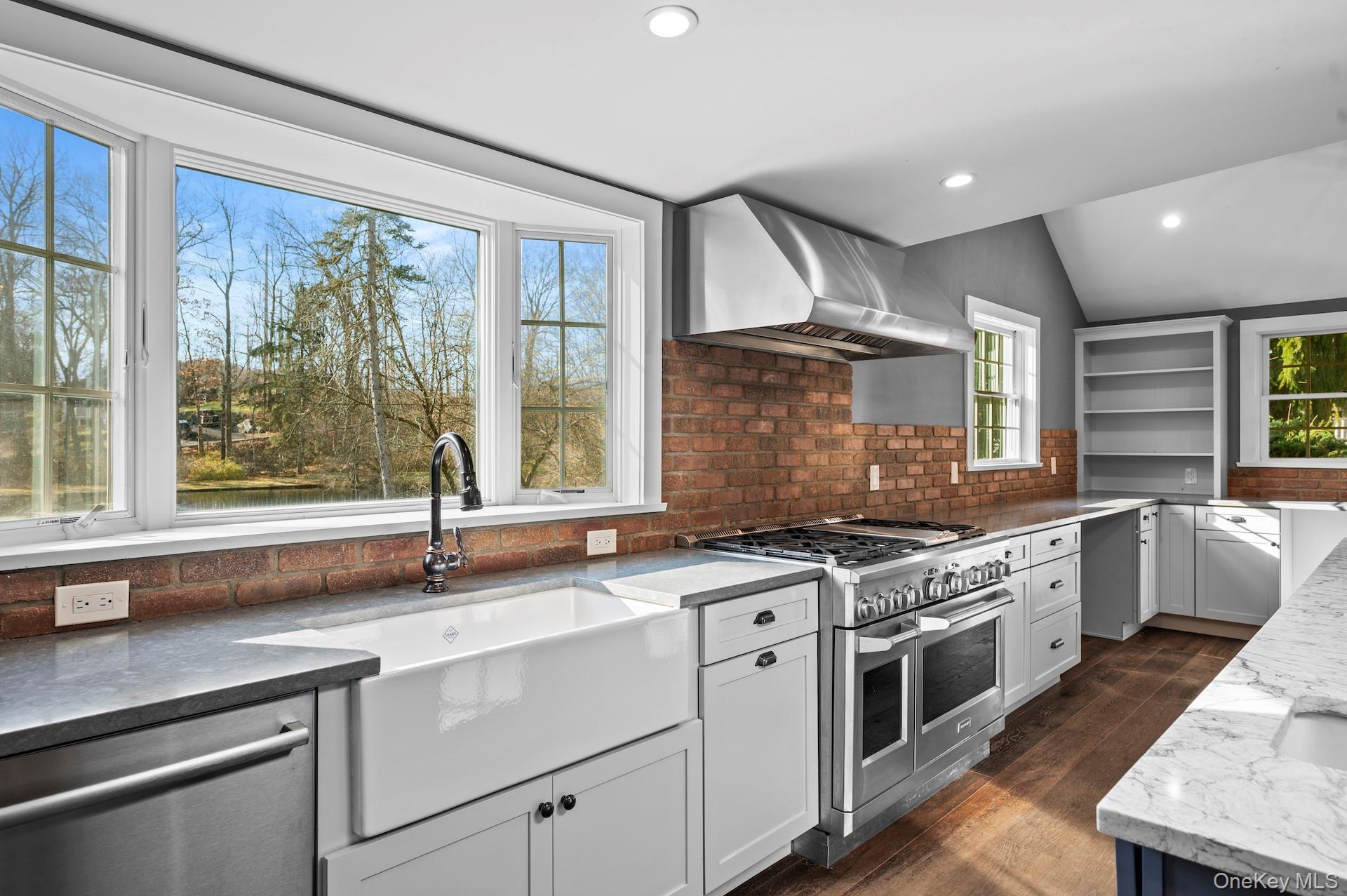 a kitchen with a sink stove and cabinets
