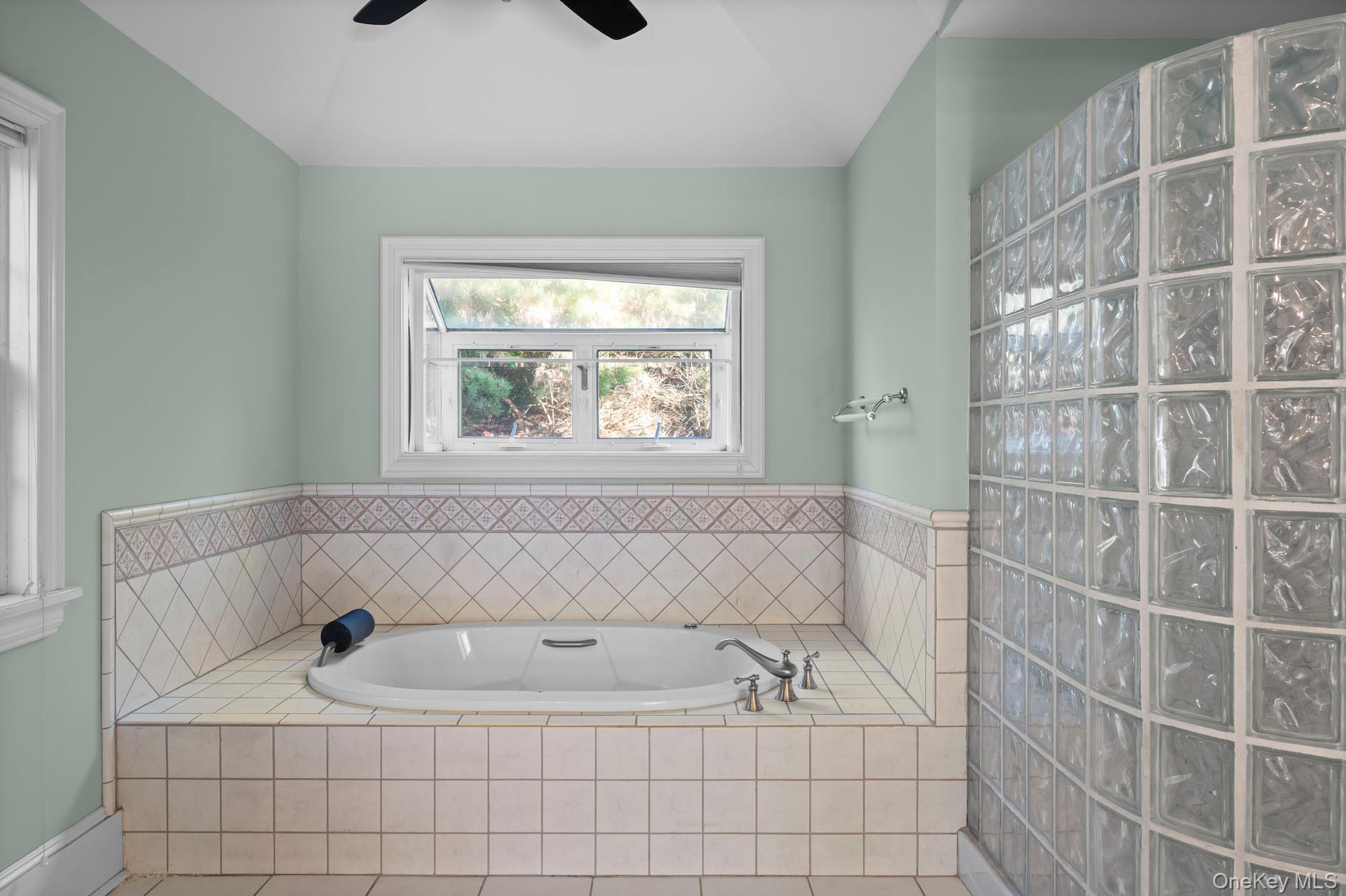 82 Shingle House Road Millwood, NY 10546 - Photo 19 of 50 a bathroom with a tub a window and a shower