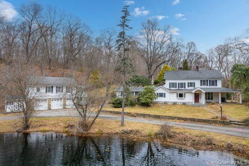 82 Shingle House Road Millwood, NY 10546 - Photo 2 of 50 a front view of a house with a yard and large trees