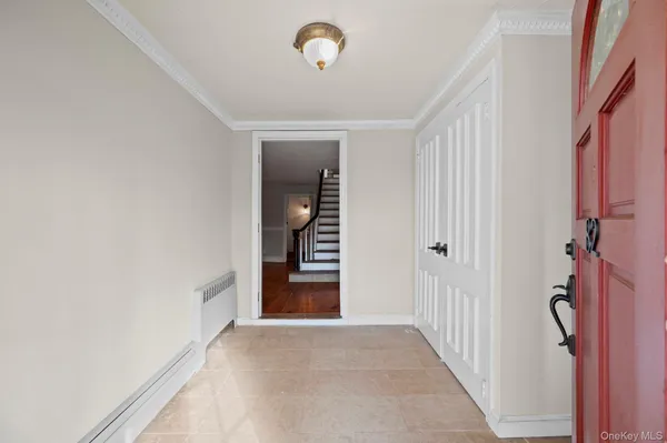 an entryway to room with wooden floor and stairs