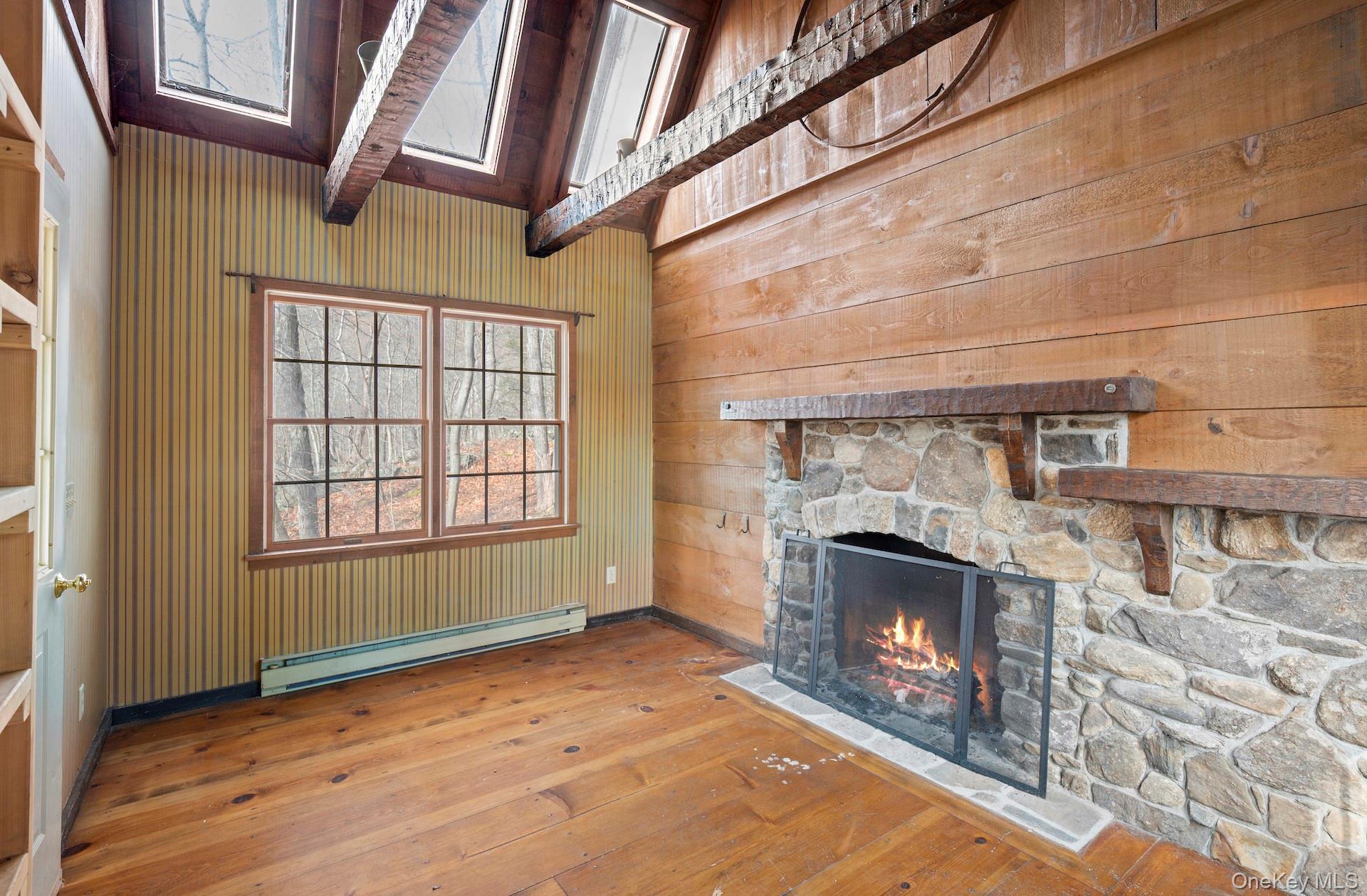 82 Shingle House Road Millwood, NY 10546 - Photo 44 of 50 a view of an empty room with wooden floor fireplace and a window