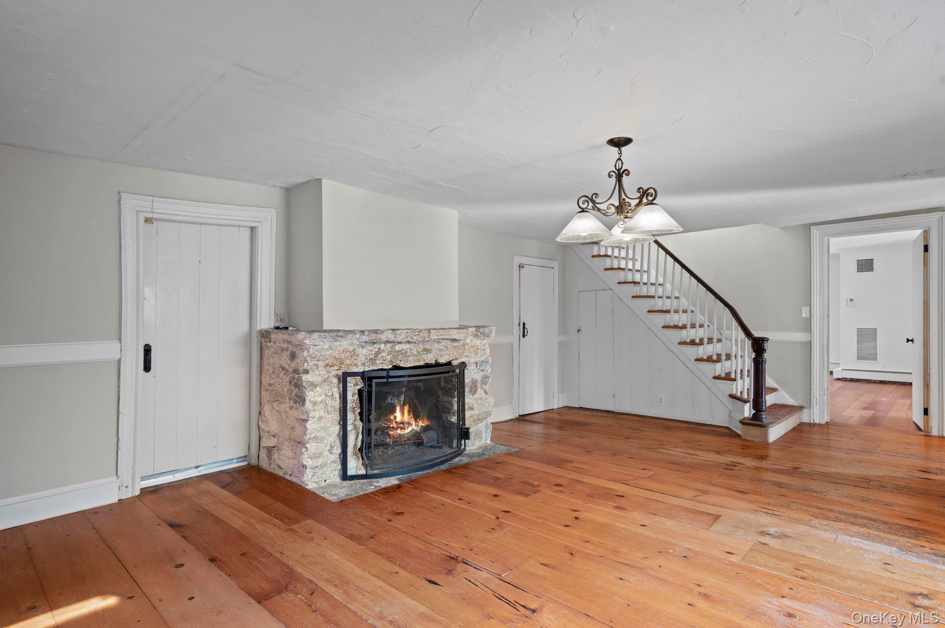 82 Shingle House Road Millwood, NY 10546 - Photo 5 of 50 a view of an empty room with wooden floor fireplace and a window