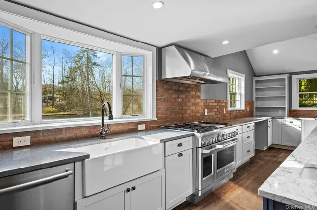a kitchen with a sink stove and cabinets