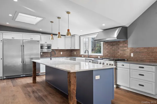 a kitchen with a sink stainless steel appliances and cabinets
