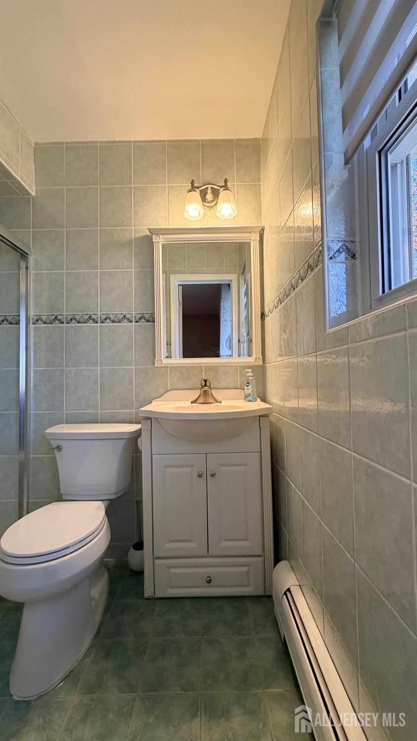 363 Cranbury Road, Unit D16 East Brunswick, NJ 08816 - Photo 15 of 32 a bathroom with a sink a toilet and shower