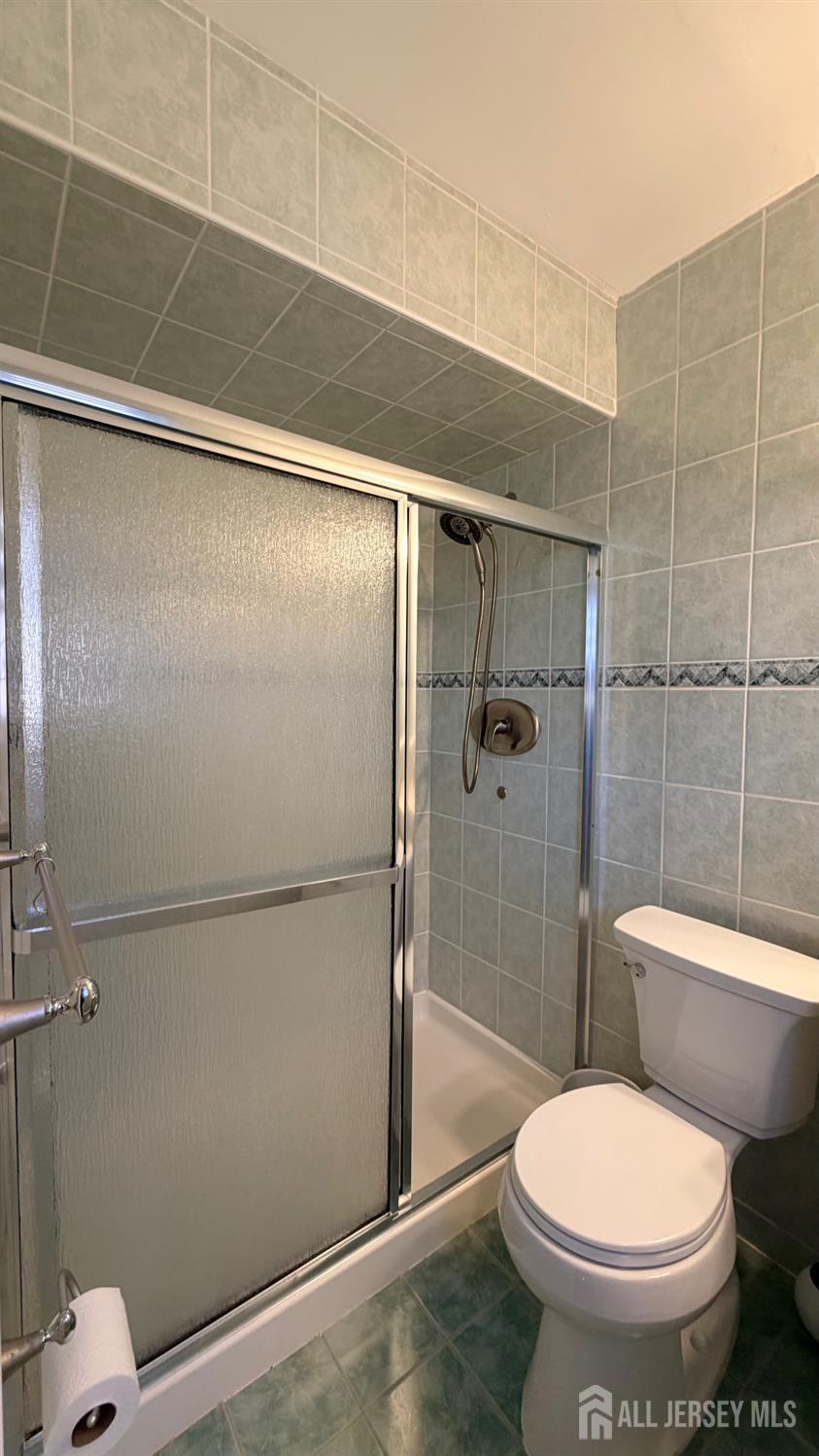 363 Cranbury Road, Unit D16 East Brunswick, NJ 08816 - Photo 16 of 32 a white toilet sitting next to a bathroom