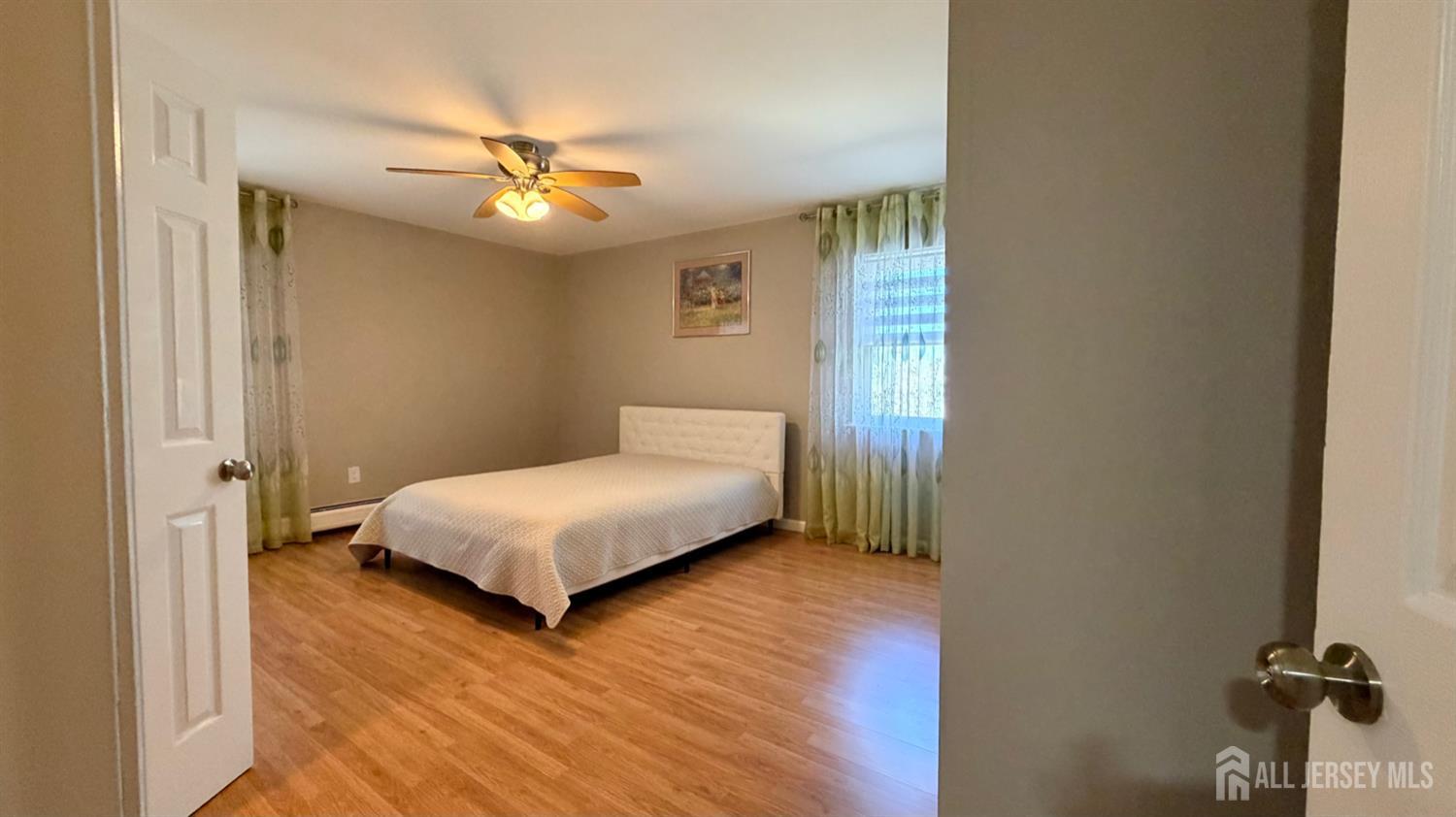 363 Cranbury Road, Unit D16 East Brunswick, NJ 08816 - Photo 18 of 32 a bedroom with a bed and a chandelier