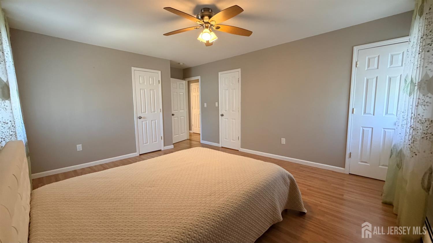 363 Cranbury Road, Unit D16 East Brunswick, NJ 08816 - Photo 19 of 32 a bedroom with a bed and a chandelier