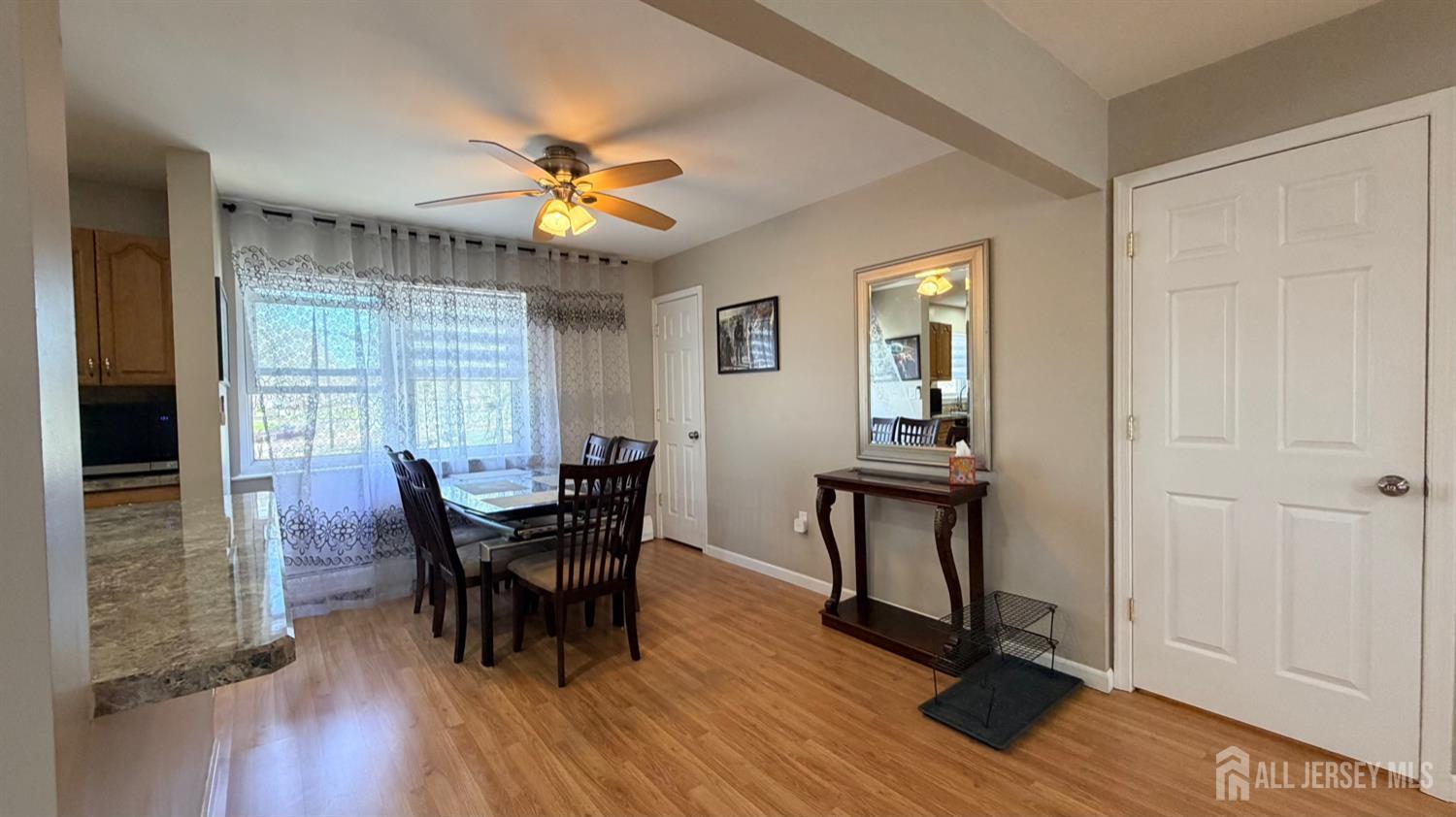 363 Cranbury Road, Unit D16 East Brunswick, NJ 08816 - Photo 2 of 32 a dining room with chandelier and wooden floor