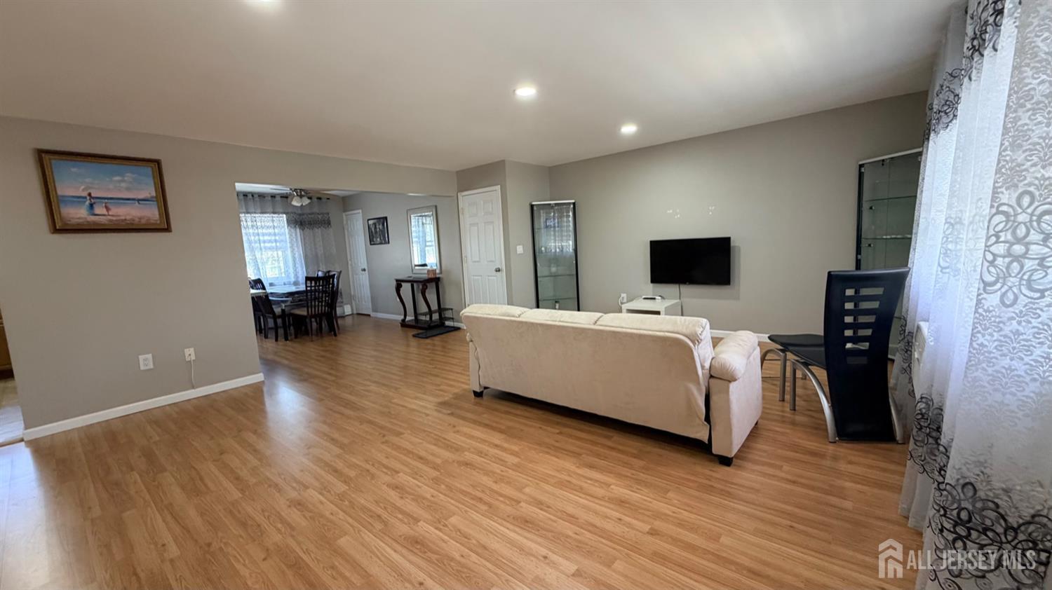 363 Cranbury Road, Unit D16 East Brunswick, NJ 08816 - Photo 21 of 32 a living room with furniture and a flat screen tv