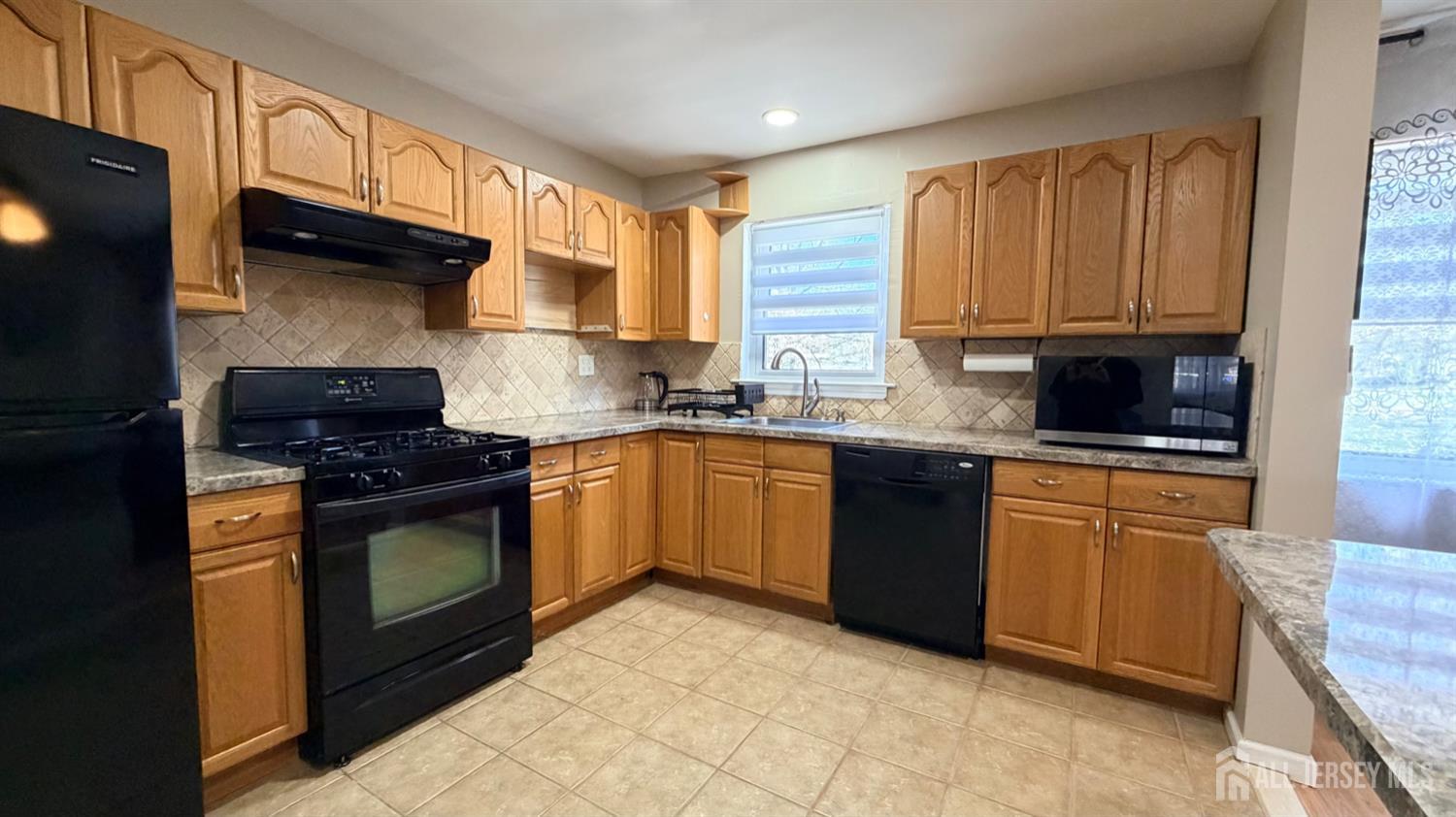 363 Cranbury Road, Unit D16 East Brunswick, NJ 08816 - Photo 26 of 32 a kitchen with stainless steel appliances granite countertop a stove a sink and a microwave