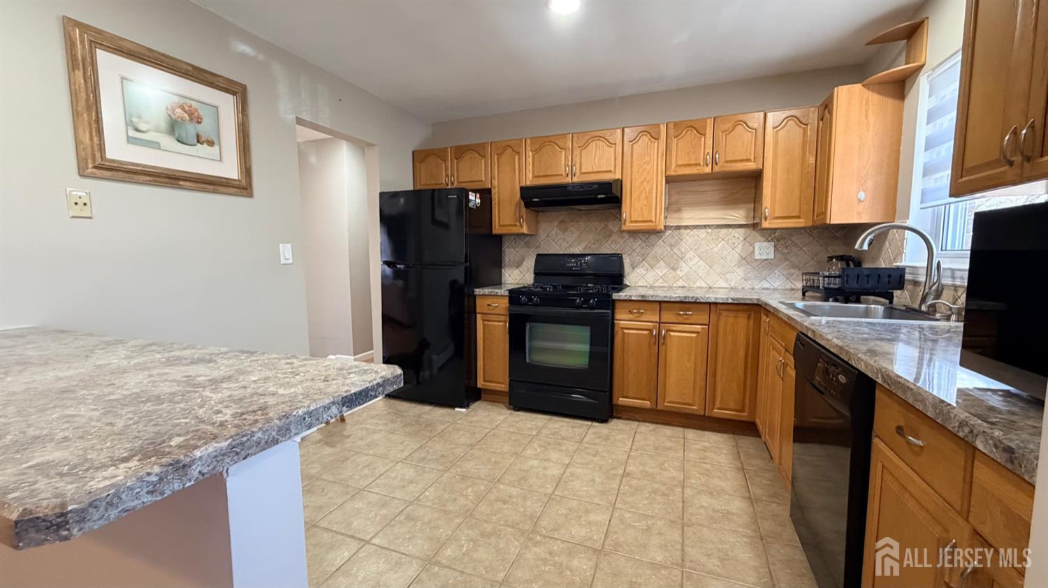 363 Cranbury Road, Unit D16 East Brunswick, NJ 08816 - Photo 27 of 32 a kitchen with stainless steel appliances granite countertop a stove refrigerator sink and microwave