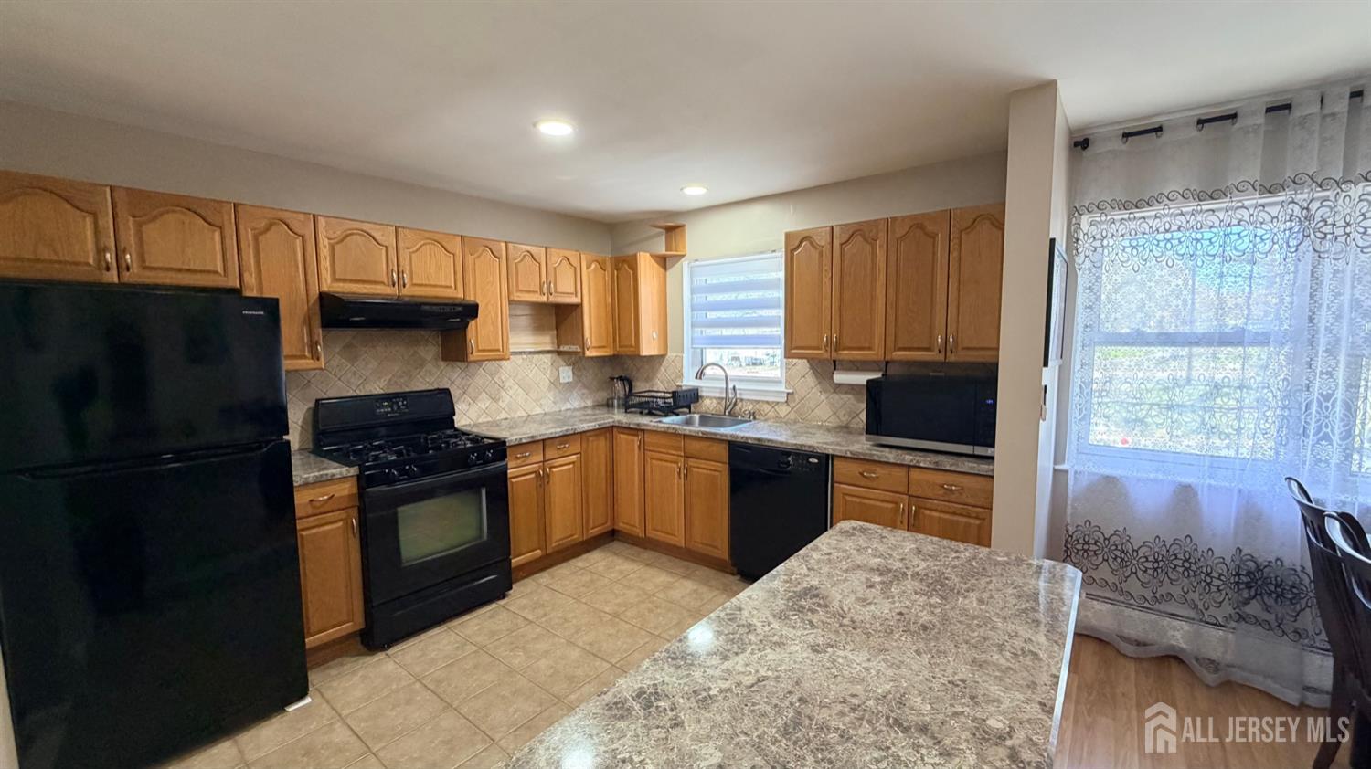 363 Cranbury Road, Unit D16 East Brunswick, NJ 08816 - Photo 7 of 32 a kitchen with granite countertop a refrigerator stove top oven and sink