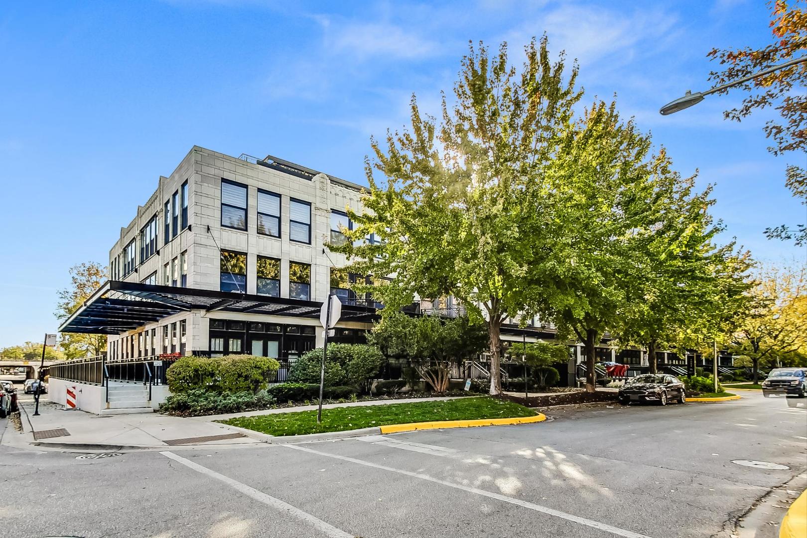1001 West 15th Street, Unit 241 Chicago, IL 60608 - Photo 1 of 41 a view of a building with a garden and trees