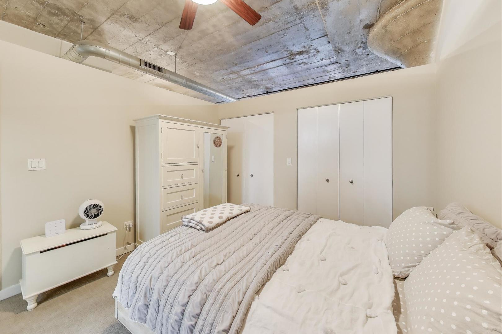 1001 West 15th Street, Unit 241 Chicago, IL 60608 - Photo 13 of 41 a bedroom with a bed and a couch