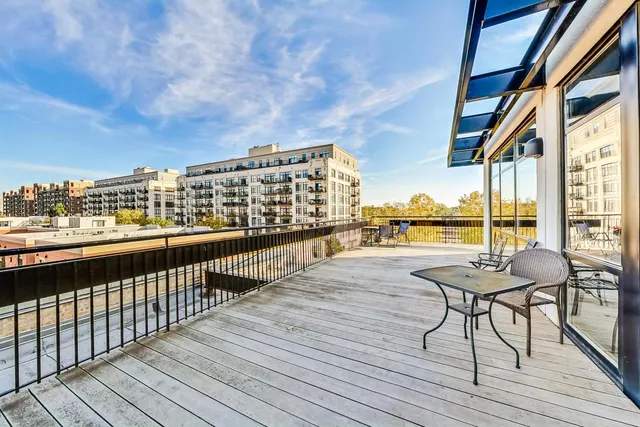 a view of balcony with furniture and wooden floor