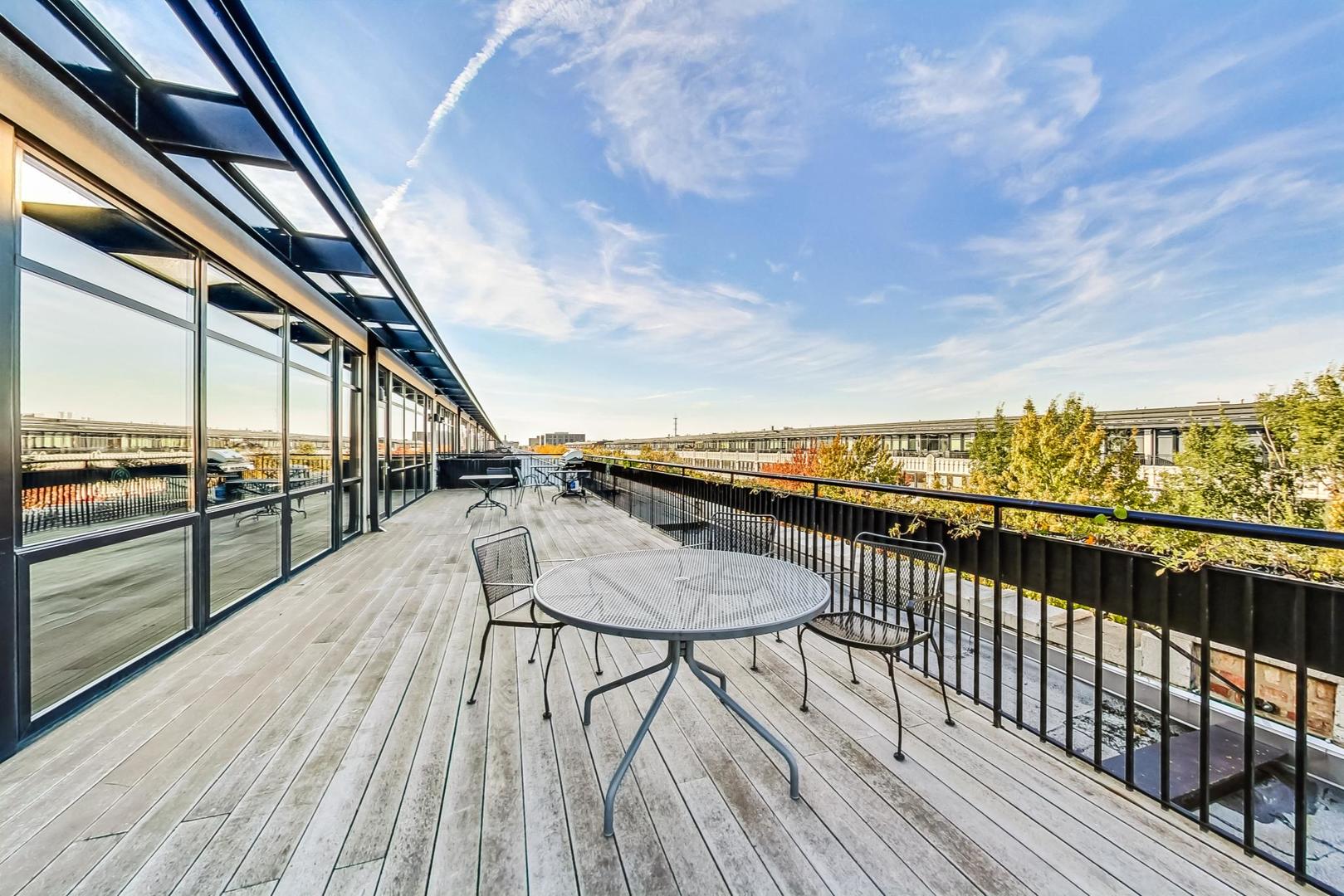 1001 West 15th Street, Unit 241 Chicago, IL 60608 - Photo 24 of 41 a view of balcony with furniture and wooden floor